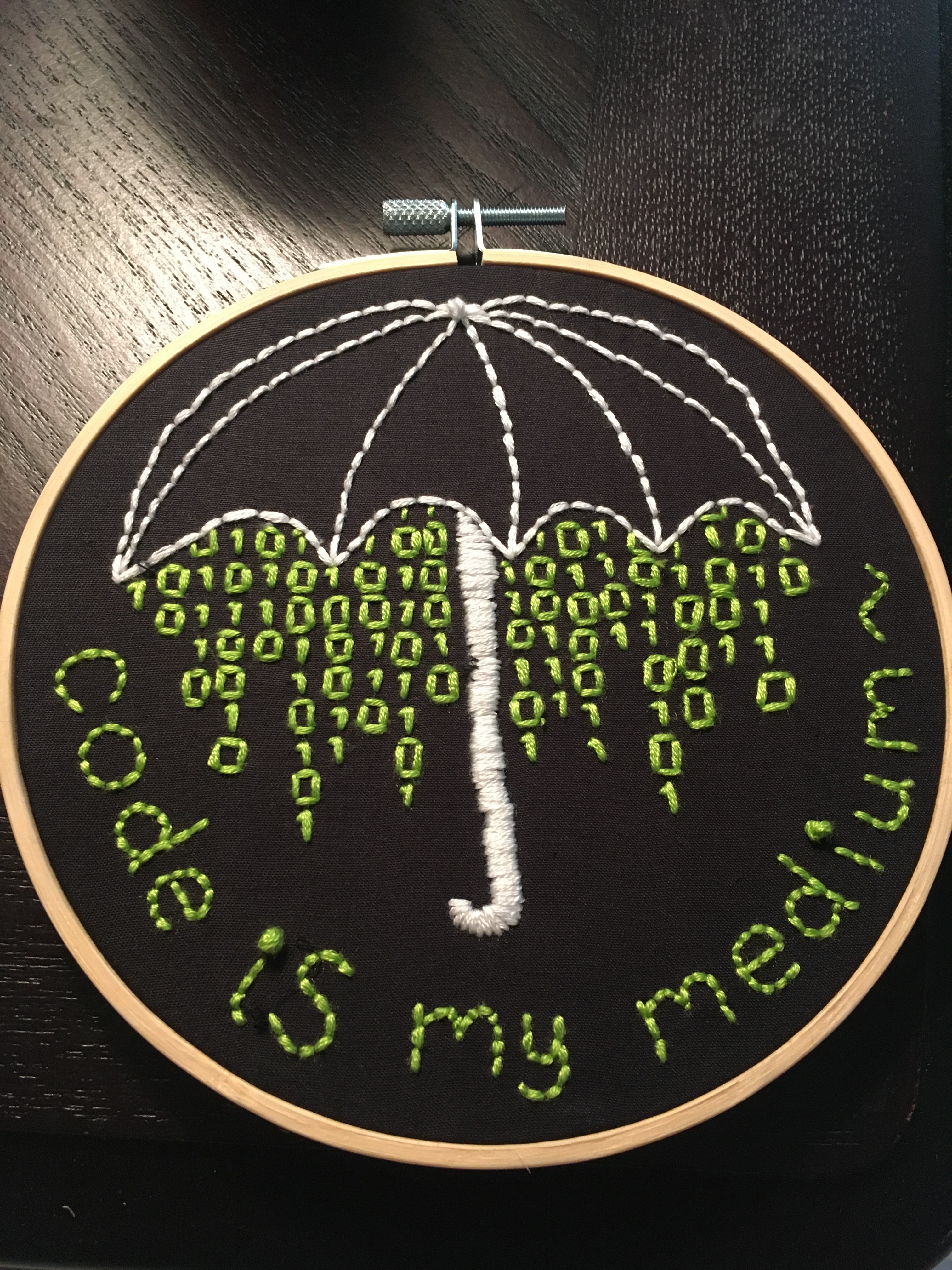 binary raining from an umbrella with the words code is mhy medium