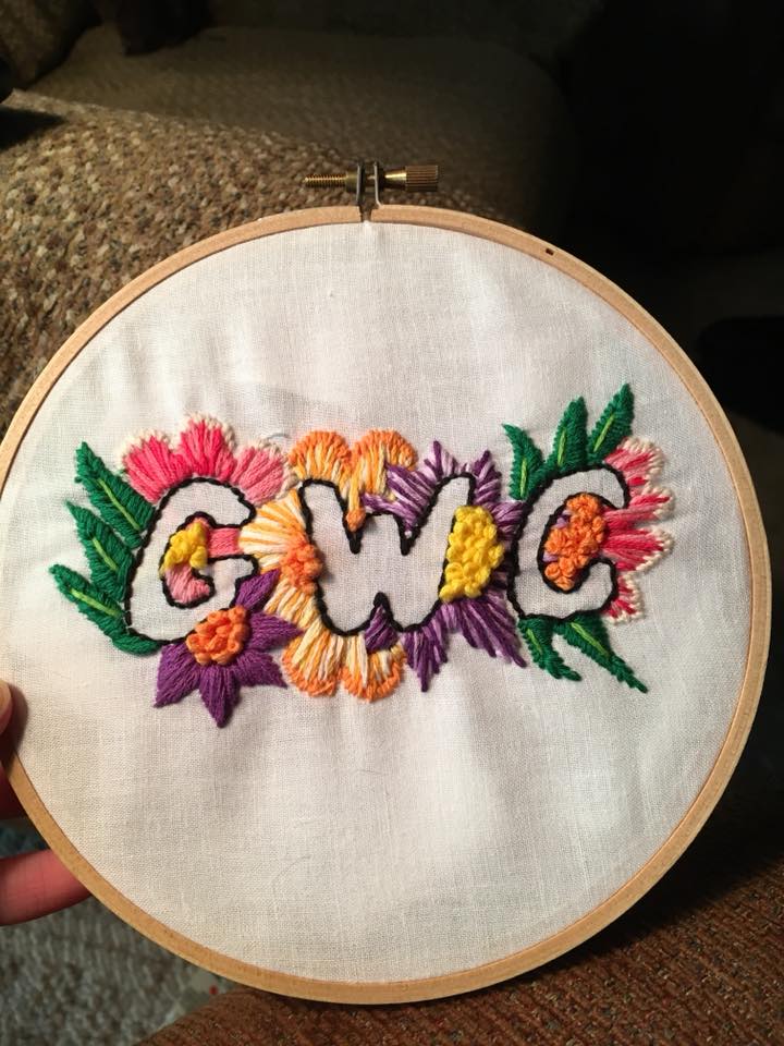 the letters g w c surrounded by flowers